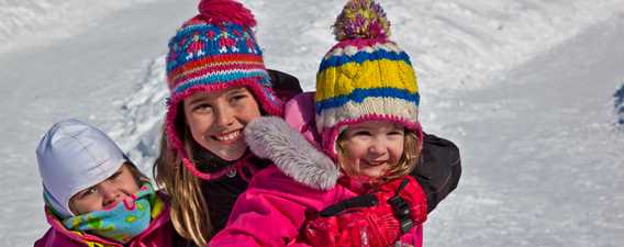 Children who slide in the winter at Féérie d'hiver de Saint-Donat