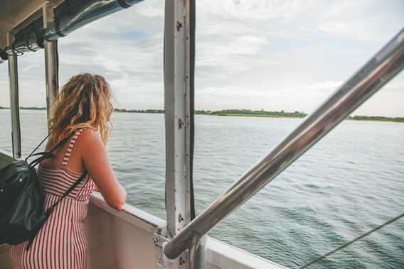 Femme qui regarde le fleuve Saint-Laurent à bord d'un bateau de croisière