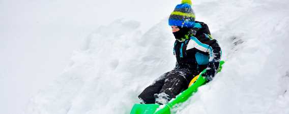 Boy sliding on the snow