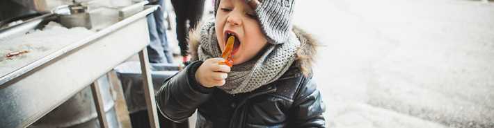 Little boy eating maple taffee at maple grove L'aKabane