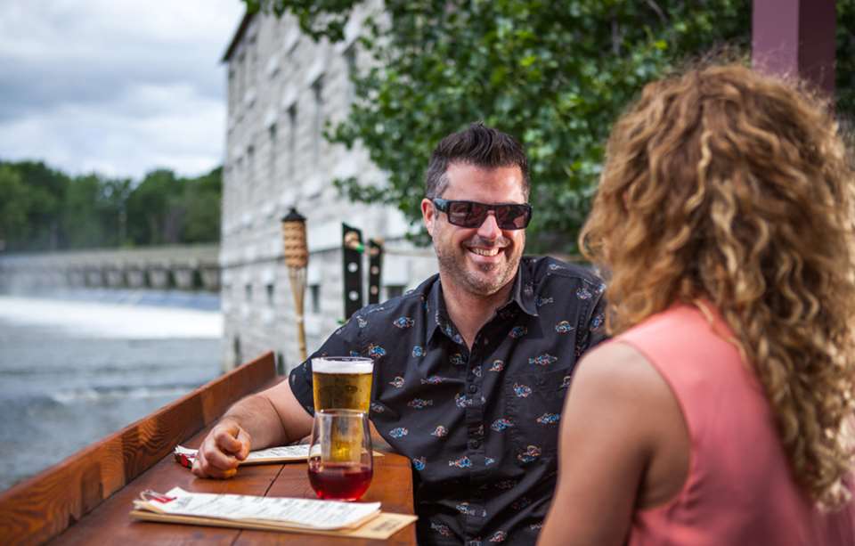 Couple having a drink at l'Île-des-Moulins