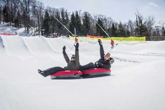 Couple at the slides during winter at Ski Montcalm