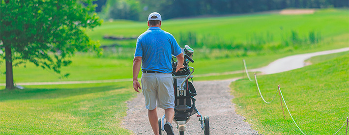 Man carrying his golf bag