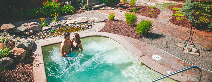 two people enjoying the outdoor spa