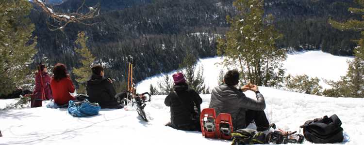 Faire de la raquette entre amis au sommet d'une montagne dans Lanaudière