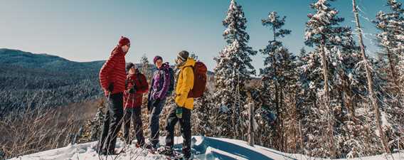 Snowshoeing with friends on the trail l'Envol