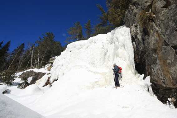 A man snowshoeing on the trail belvedere at Saint-Côme